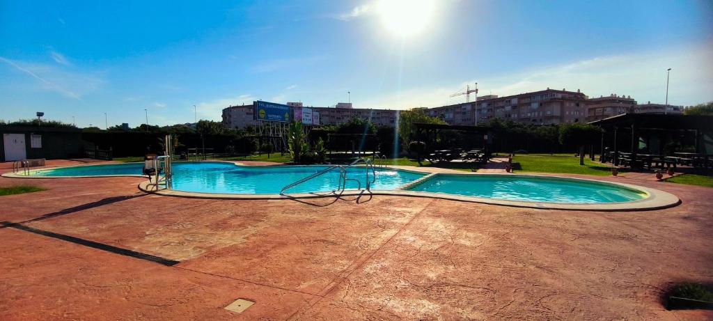 トレビエハにあるBungalow in Parque Las Naciones with Communal Poolのブランコ付きの空のスイミングプール