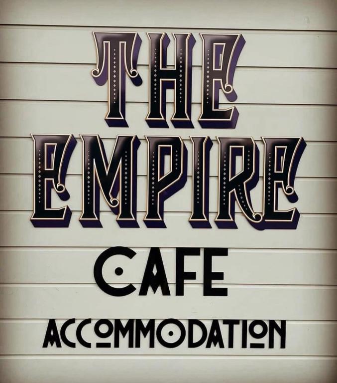 a sign that reads the emergency cafe association at Empire Cafe & Accommodation in Kumara