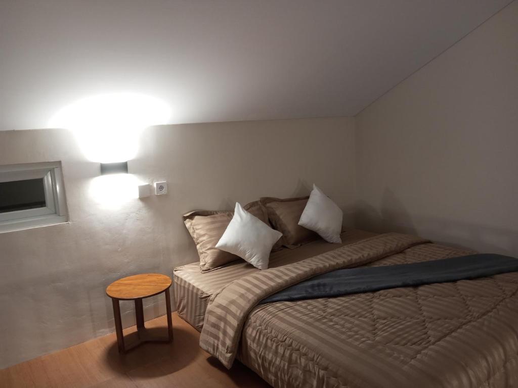 a small bedroom with a bed and a table at Apartment in Sanur Harbour in Sanur