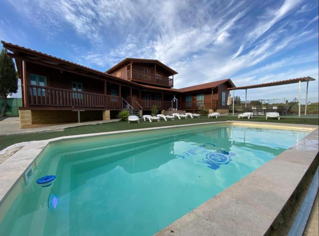 a large pool in front of a house at Hacienda el Capricho in Cartaya