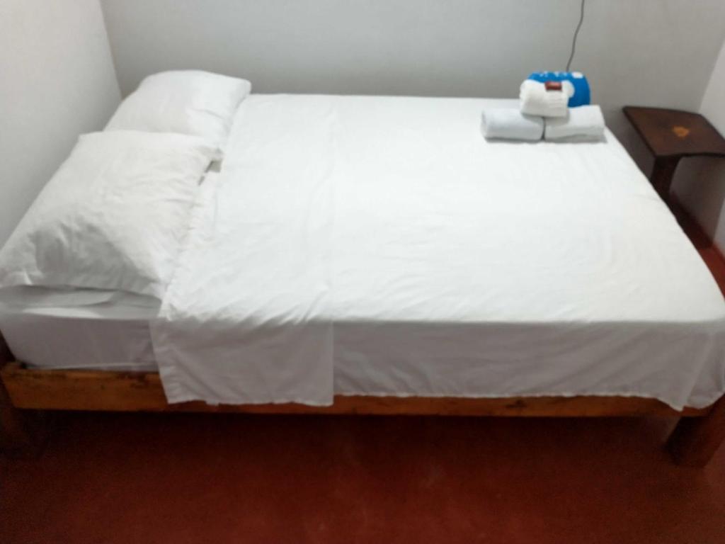 une chambre avec un lit avec des draps blancs dans l'établissement Casa de descansó la pradera, 