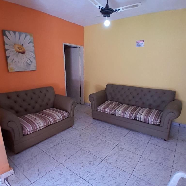 a living room with two couches in a room at Refúgio da Paz - Itanhaém in Itanhaém