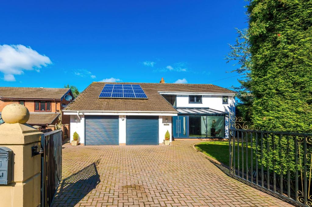 a house with a garage with solar panels on the roof at Contractor Stay Sanibel 5BR LongTerm Ready in Hawarden