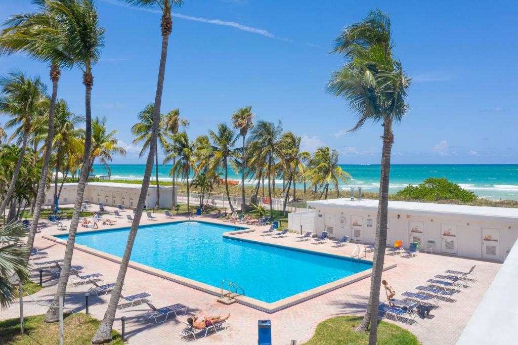 an aerial view of a resort with a pool and palm trees at Casablanca Residences Miami Beach in Miami Beach