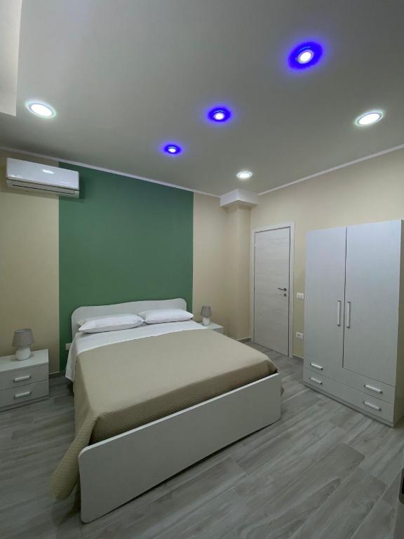 a bedroom with a bed and blue lights on the ceiling at B&B Costa d'Amalfi Bellizzi in Bellizzi