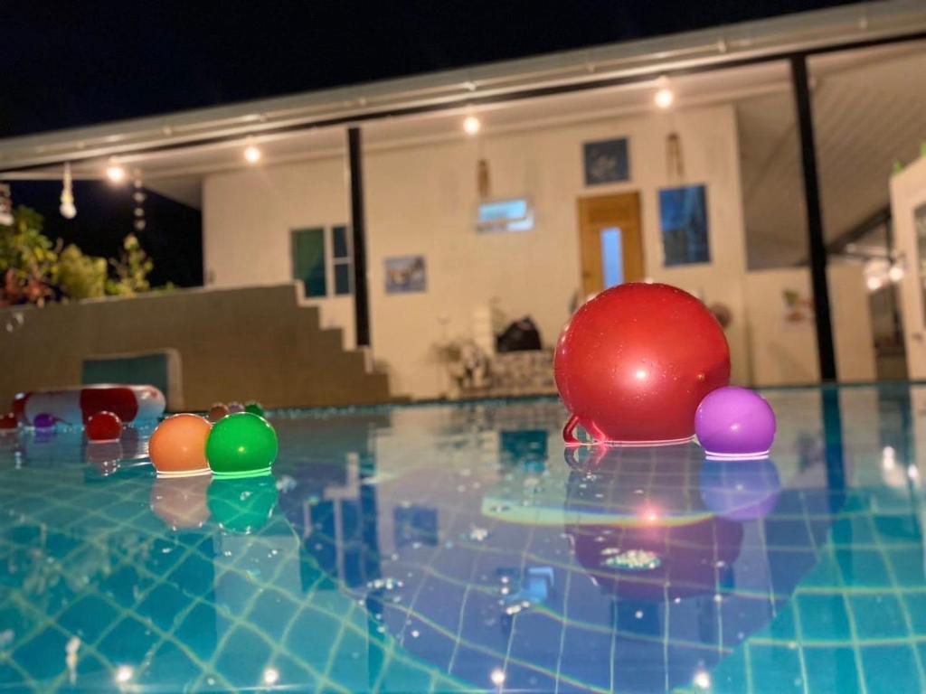 a pool with colorful balls on top of it at Aoonilay Resort Chaam-Huahin Zone B in Ban Bang Sai Yoi