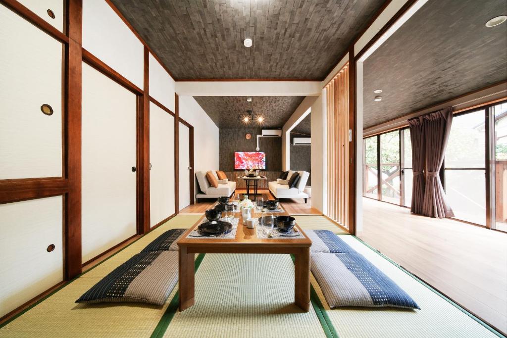 a living room with a table and chairs at 憩いの家 昭代 in Fukuoka