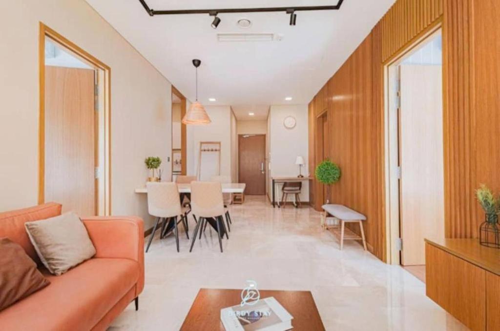 a living room with a couch and a table at Sky Suites KLCC Luxury Homestay in Kuala Lumpur