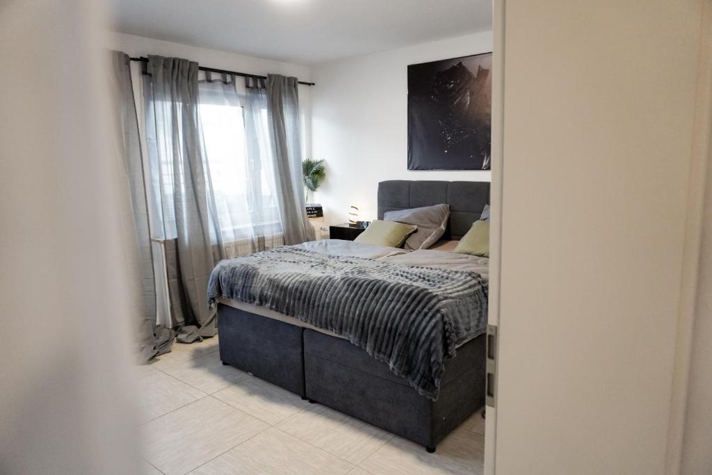 ドルトムントにあるM House Do Modernes Privatzimmer mit Balkon & Self Check-inのベッドと窓のある寝室