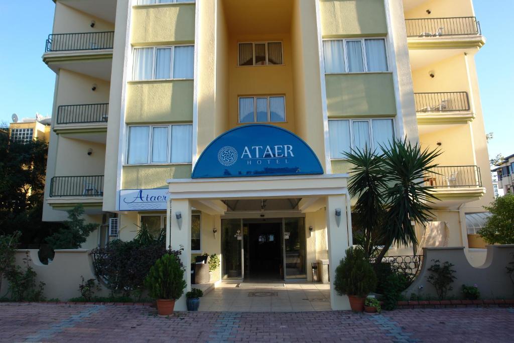 a building with a sign on the front of it at Ataer Hotel in Antalya