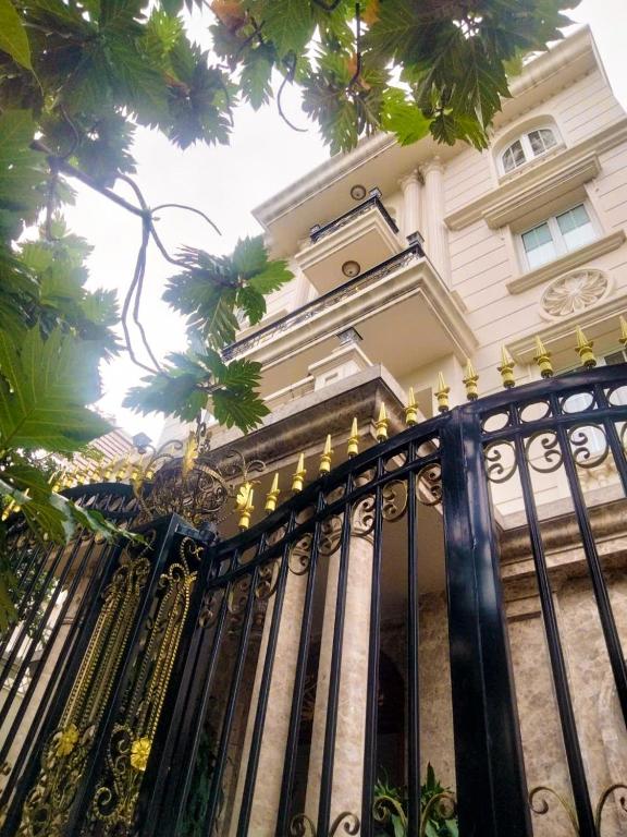 a black wrought iron fence in front of a house at Lưu trú Vạn Lợi in Ho Chi Minh City