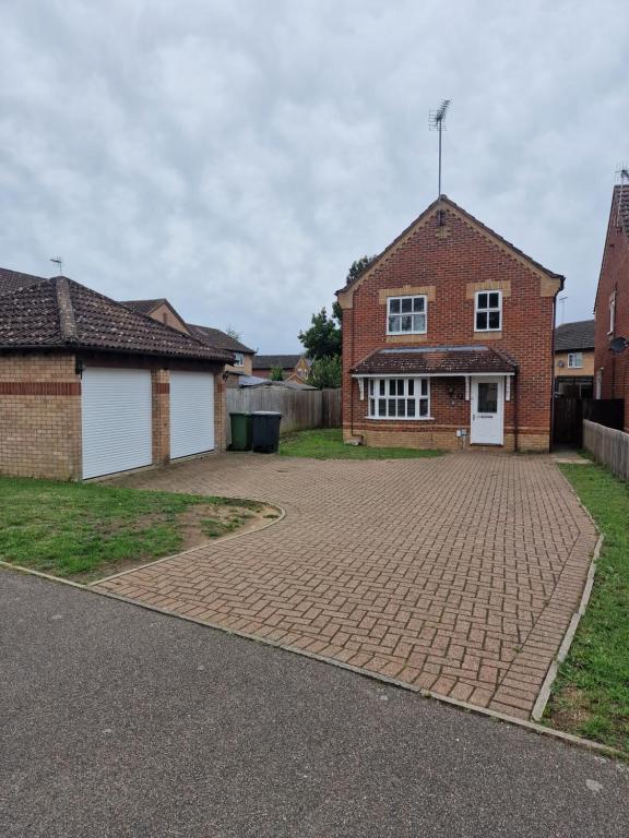 a brick driveway in front of a brick house at SK Short Let in Kilverstone