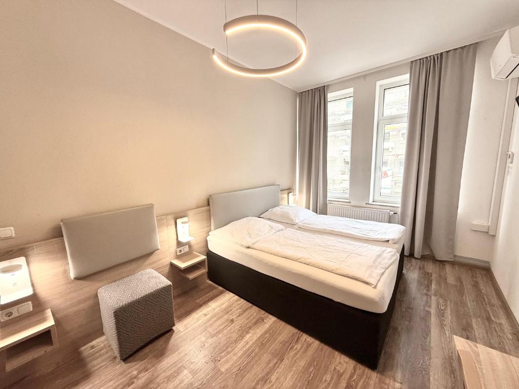 a bedroom with a bed and a large window at Central Hotel Duisburg in Duisburg
