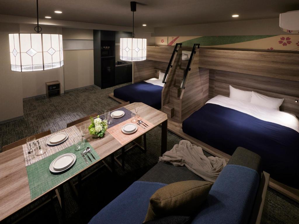 a hotel room with two beds and a table at Minn Ueno Iriya in Tokyo