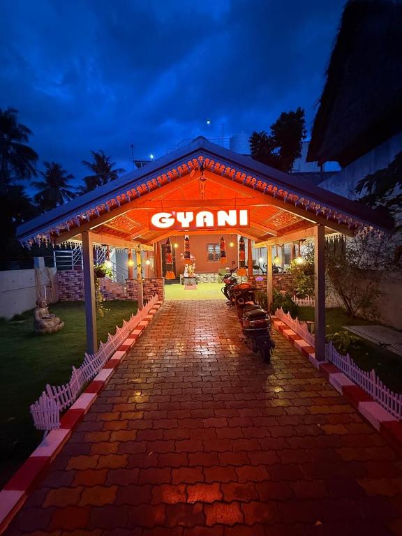 a pavilion with a sign that says gym at night at GYANi 1 in Tiruvannāmalai