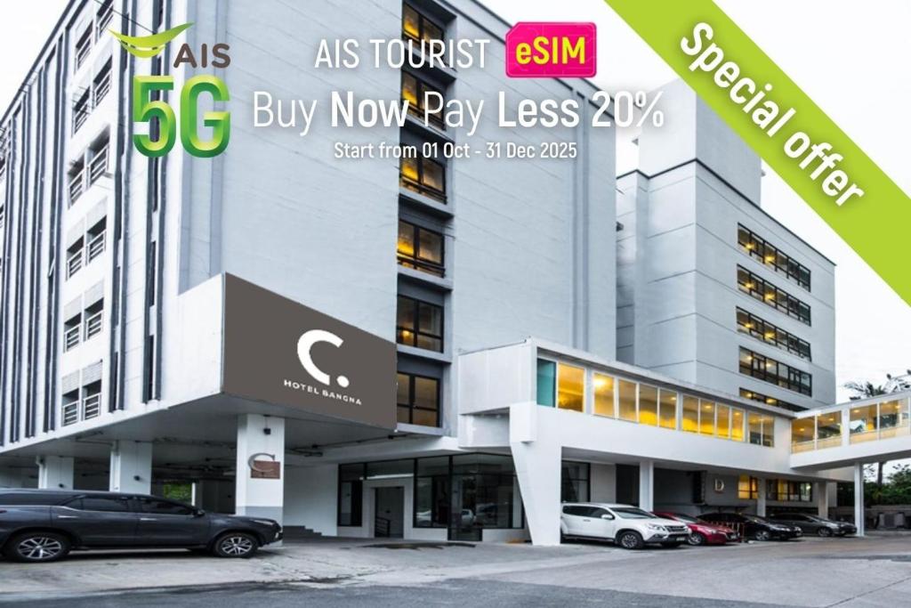 a building with cars parked in front of it at C Hotel Bangna in Bangkok