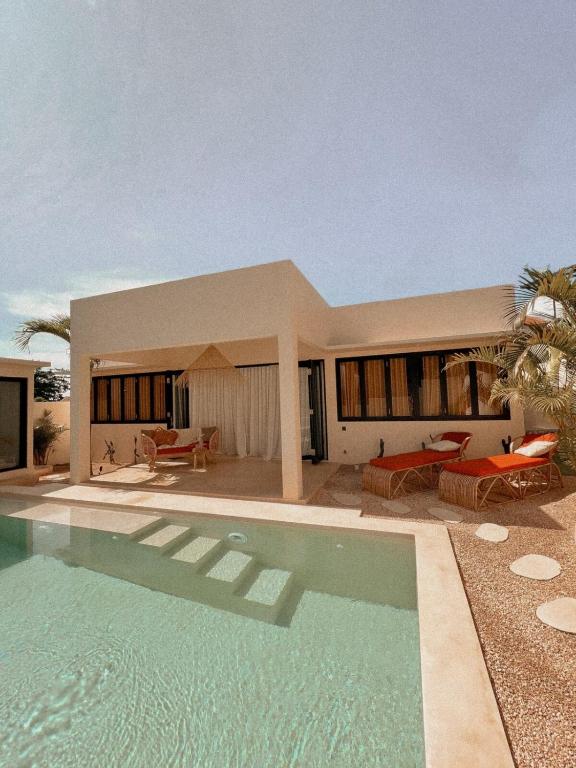 ein Haus mit einem Swimmingpool davor in der Unterkunft BAYA - Modern & Cozy 2BR Villa Uluwatu in Bingin Beach