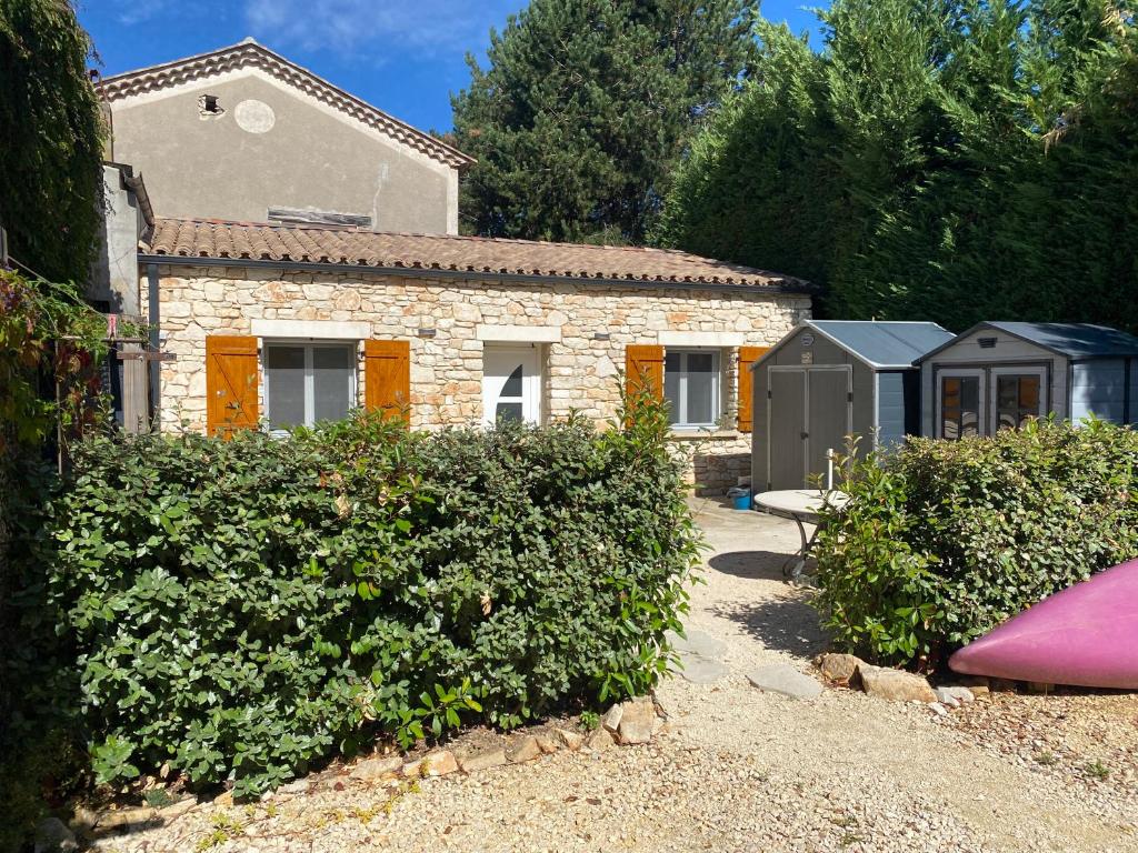a house with a garden and some bushes at L'Oustau in Saint-Martin-dʼArdèche