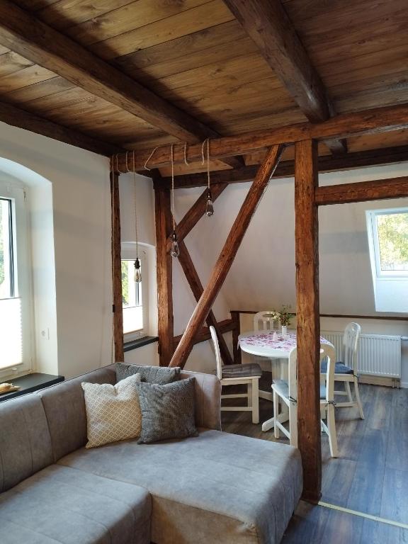 a living room with a couch and a table at Ferienhaus hERZgebirge in Bockau