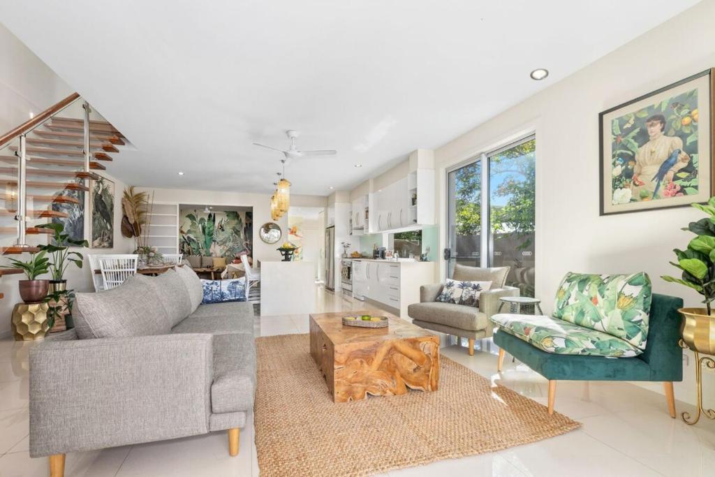 a living room with a couch and a table at Tropical Oasis - Creekside Townhouse by uHoliday in Pottsville