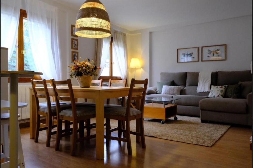 a living room with a table and chairs and a couch at Casa Marilu Sallent in Sallent de Gállego