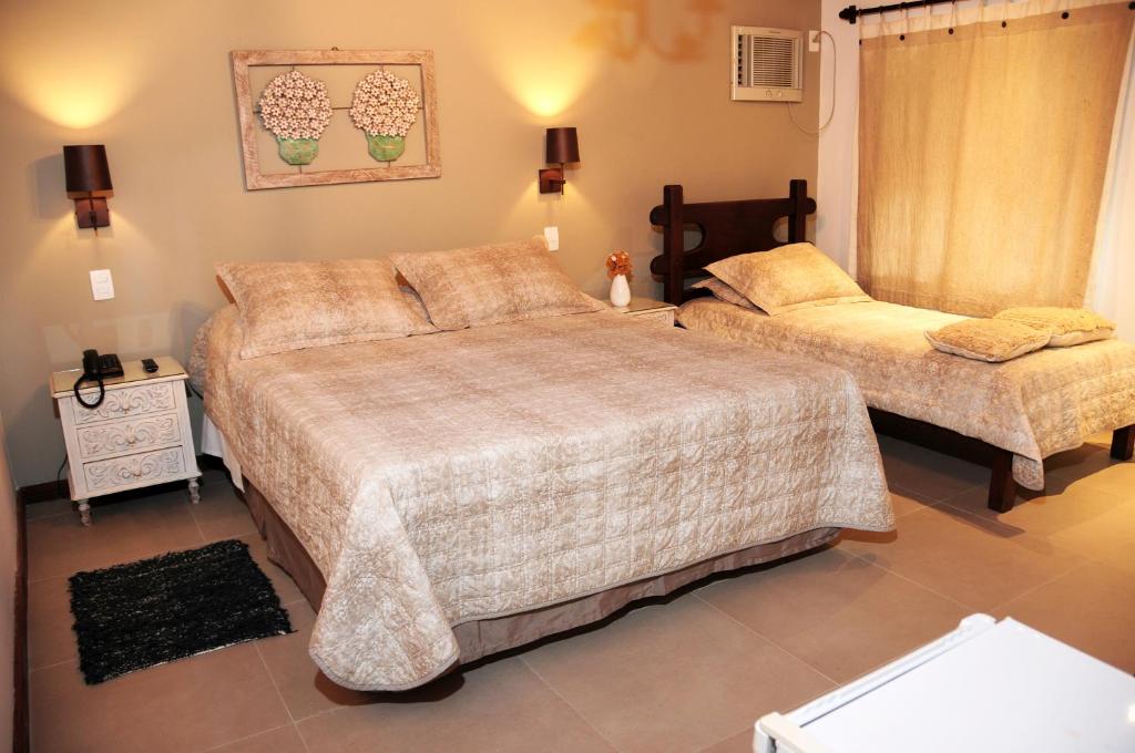 Postel nebo postele na pokoji v ubytování Hotel Daniela