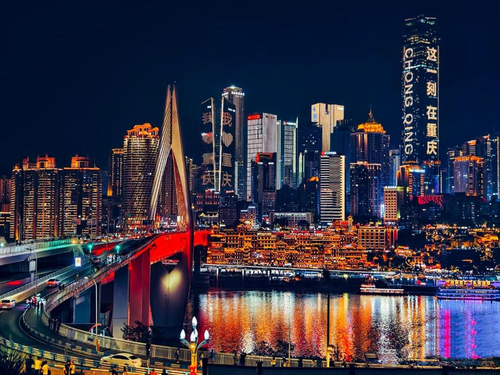 a night view of a city with a bridge at 重庆MAX范思酒店解放碑来福士店Chongqing MAX Van Hotel Jiefangbei Raffles in Chongqing