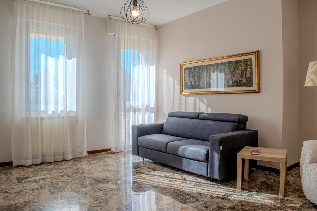 a living room with a couch and a chair at Road to Venice M&N Dolo Apartment in Dolo