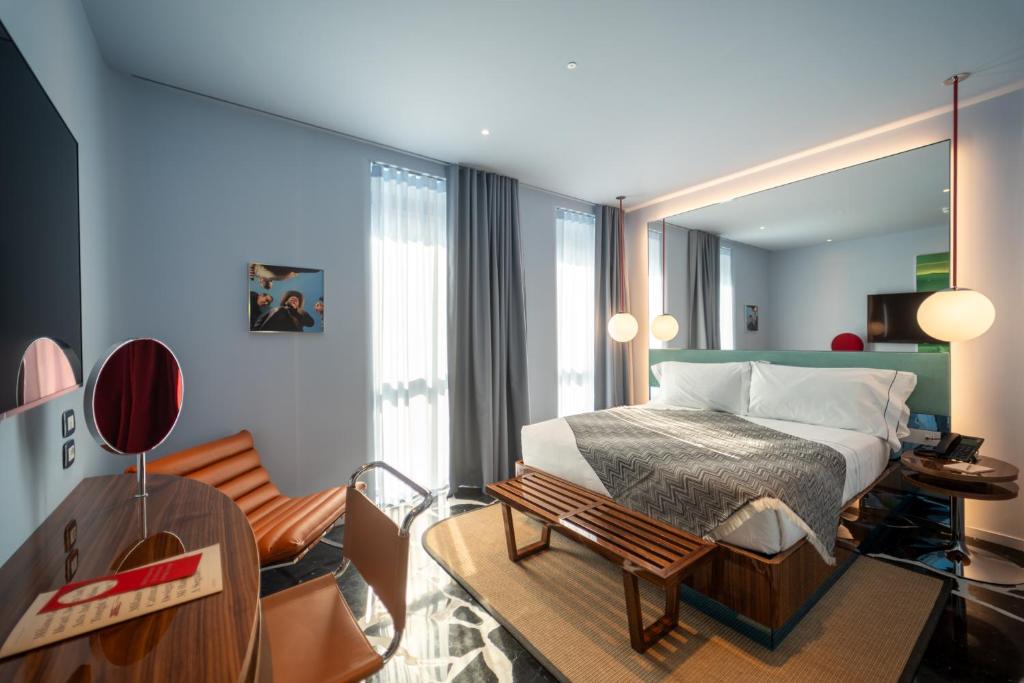 ein Schlafzimmer mit Bett und ein Wohnzimmer in der Unterkunft Hotel Calimala Milano in Mailand