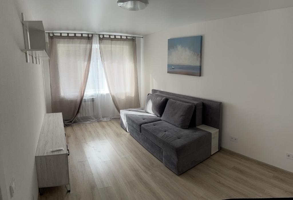 a living room with a couch and a table at Полтава Поділ по добова оренда in Poltava