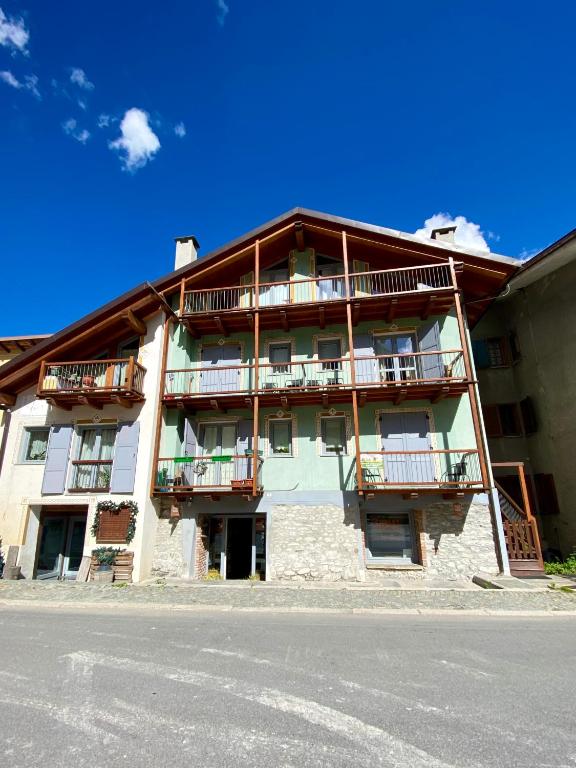 a building with balconies on the side of a street at La Casa Di Martino in Cesana Torinese