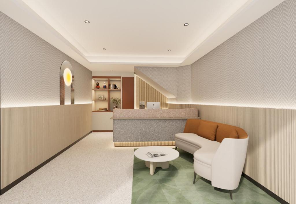 a living room with a couch and a table at A Hotel Farrer Park - Newly Renovated in Singapore