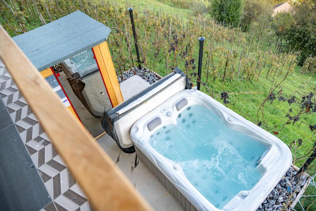 a jacuzzi tub sitting on top of a porch at Hill Stars House in Straža