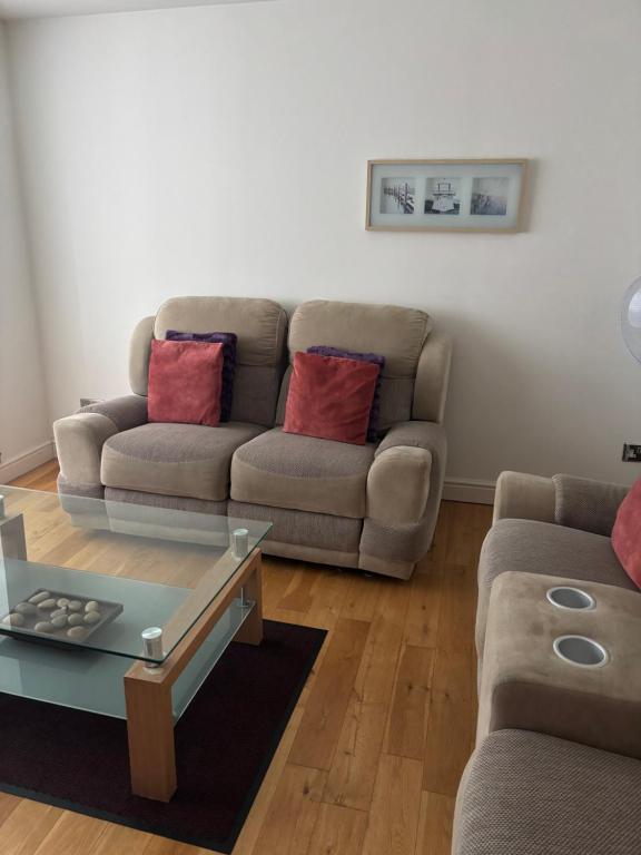 a living room with a couch and a coffee table at Thistle Tide 13 Nelson Street Largs KA308LN 1st Floor in Largs
