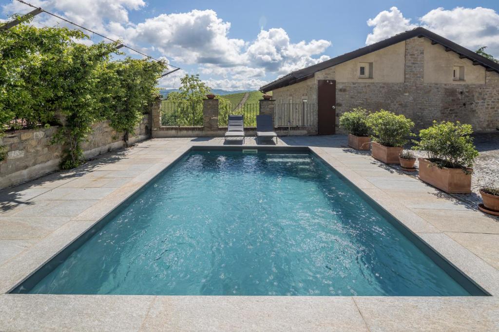 a swimming pool in the yard of a house at Renato Apartments Monforte D'alba in Monforte dʼAlba