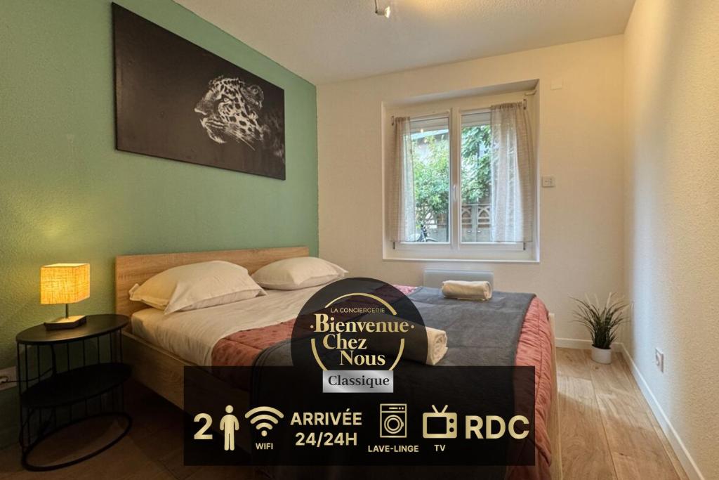 a bedroom with a bed with a sign on it at Cosy F2 , Marx Dormoy A WIFI in Clermont-Ferrand