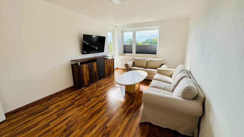 a living room with a couch and a table at Apartment Osnabrück Haste in Osnabrück