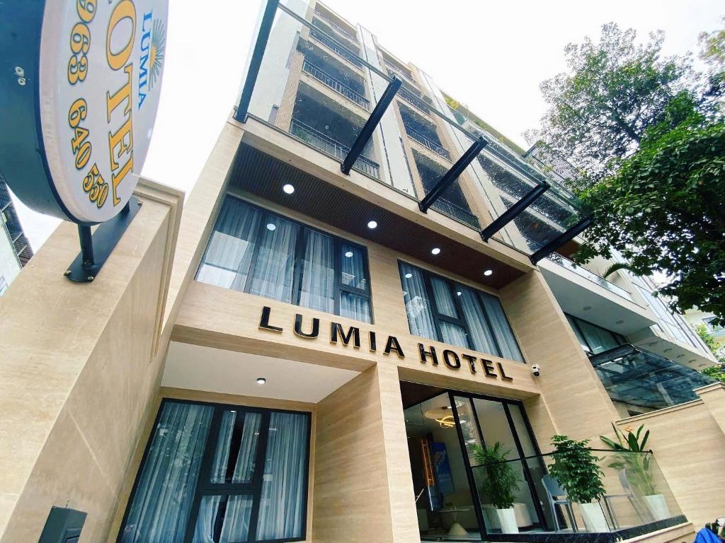 a hotel building with a sign in front of it at Lumia Hotel in Ho Chi Minh City