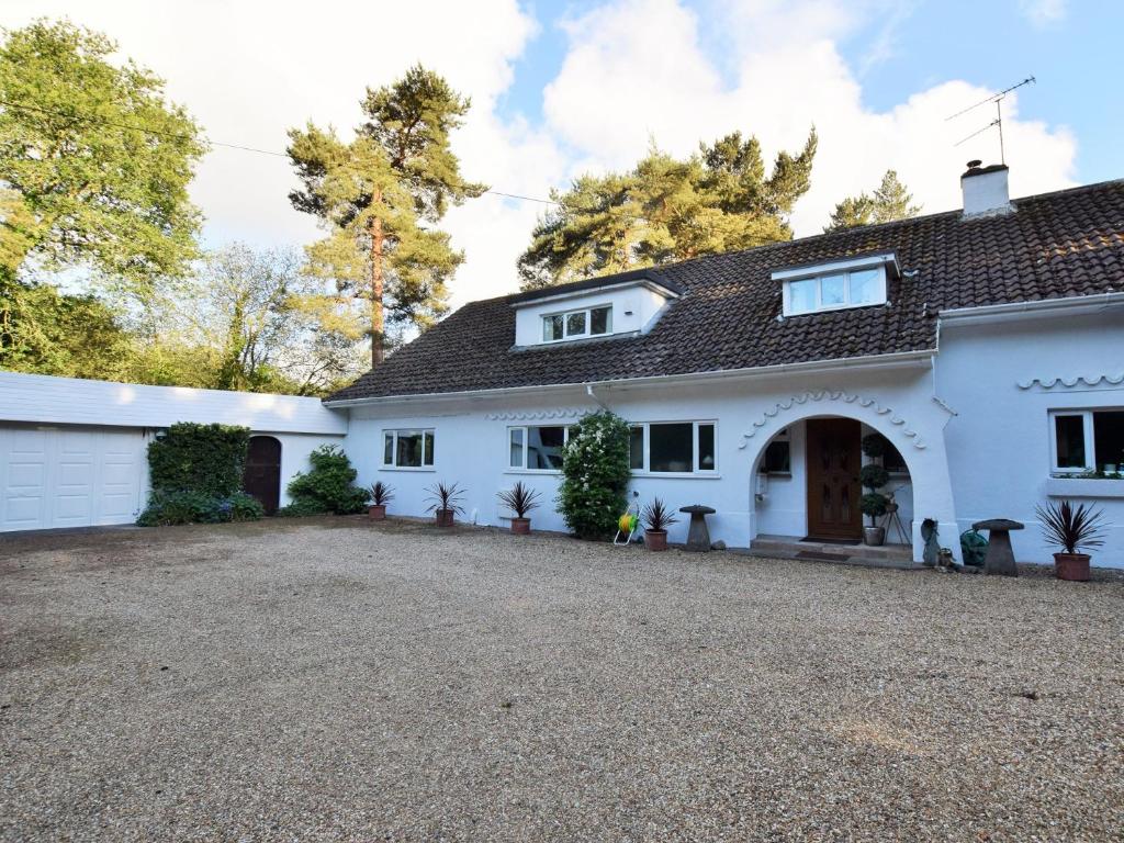 a large white house with a gravel driveway at 1 Bed in Ashley Heath 50147 in Saint Ives