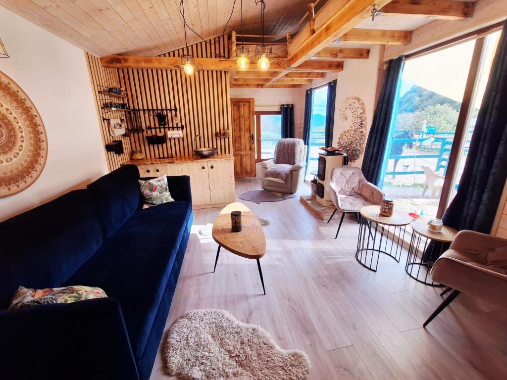 a living room with a blue couch and a table at Apartmán na detskej zážitkovej farme Fajnovô in Nová Baňa