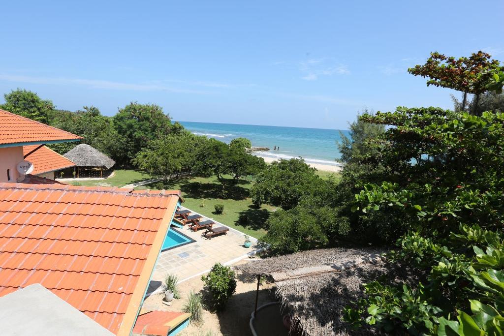 a view of the beach from the balcony of a resort at Kay Jay Beach House - Pasikudha in Pasikuda