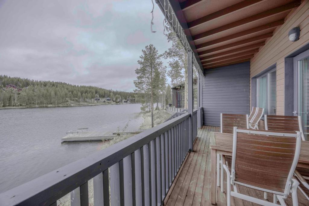 a porch with two chairs and a view of a lake at LakeVillas B4 - sis 4 kpl hissilippuja in Ukkohalla