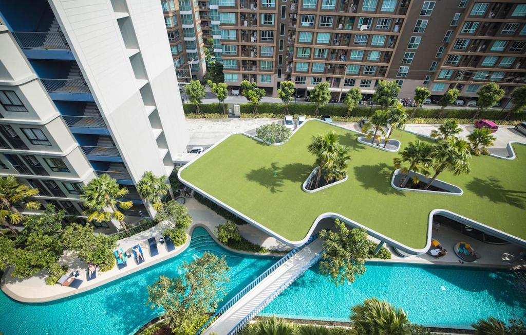 an aerial view of a resort with two pools and palm trees at Entire apartment in Kathu, Phuket, Thailand in Kathu