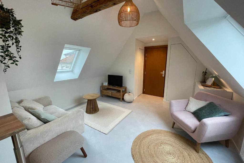 a living room with a couch and a tv at La Girouette in the heart of a farmhouse in Mittelhausbergen