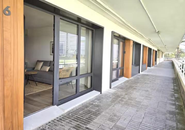 an empty hallway of a building with glass windows at Playa Sardinero Little Homes 6 in Santander