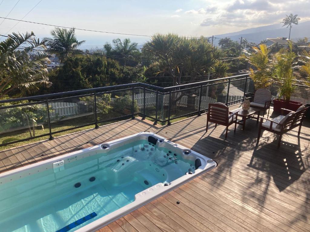 a swimming pool on the deck of a house at Ty Lodge in Les Trois Mares