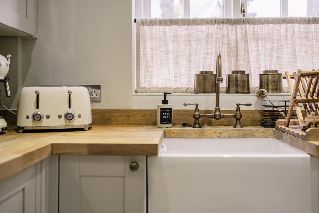 eine Küchentheke mit einem Toaster und einer Spüle in der Unterkunft Beautiful 3 Bedroom Home in Chipping Norton in Chipping Norton