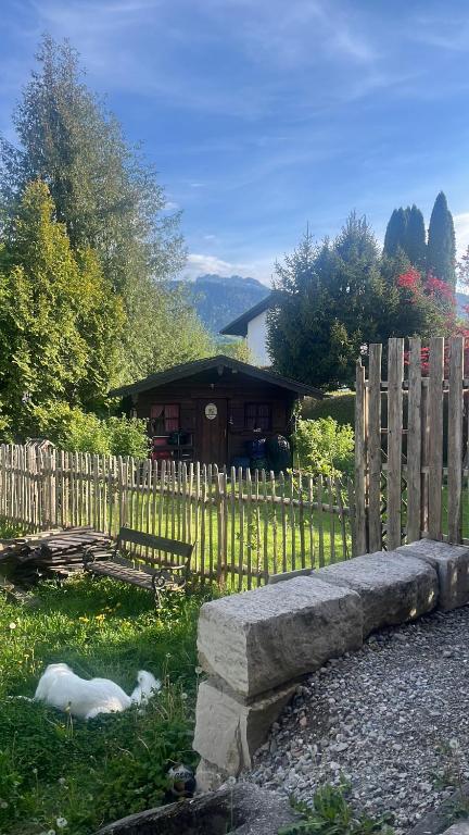 a wooden fence in front of a house at Rufus' Bergblick in Bernau am Chiemsee