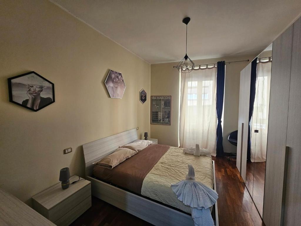 a bedroom with a large bed and a window at Suite del Suffragio in Viterbo