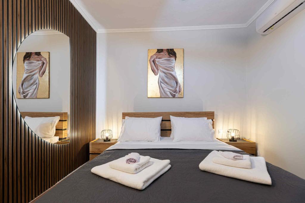 a bedroom with a bed with two towels on it at Seluna Apartment in Komotini